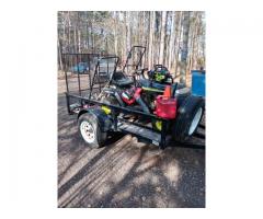 Trailer with riding lawnmower and tools